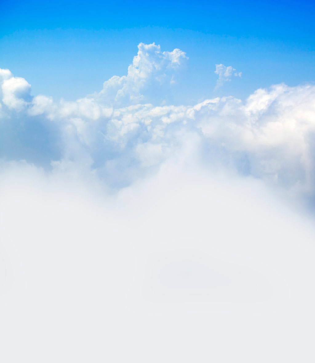 Soft white clouds drifting across a bright blue sky, conveying a calm and open atmosphere